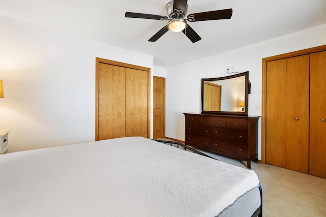 301 Hugh St, East Jordan, MI 49727 - bedroom with light colored carpet, multiple closets, and ceiling fan