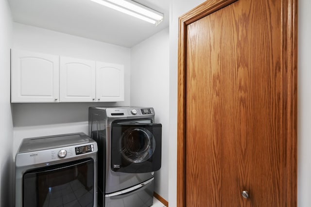 301 Hugh St, East Jordan, MI 49727 - laundry area featuring washer and dryer and cabinet space