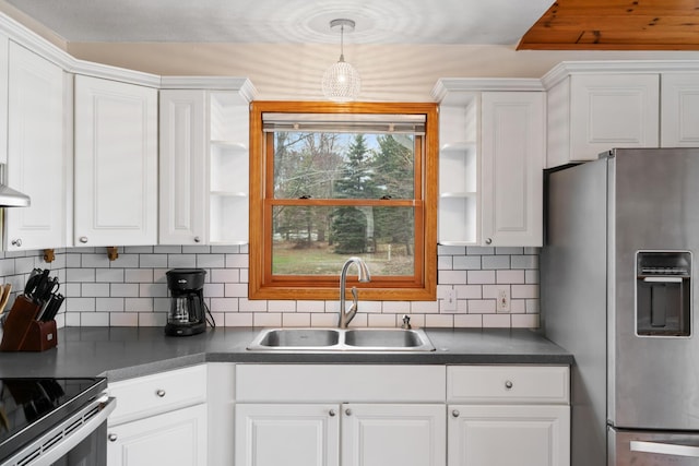 301 Hugh St, East Jordan, MI 49727 - kitchen featuring stainless steel fridge, a sink, dark countertops, and open shelves