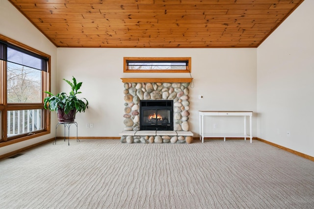 301 Hugh St, East Jordan, MI 49727 - living area with lofted ceiling, carpet flooring, wood ceiling, a stone fireplace, and baseboards