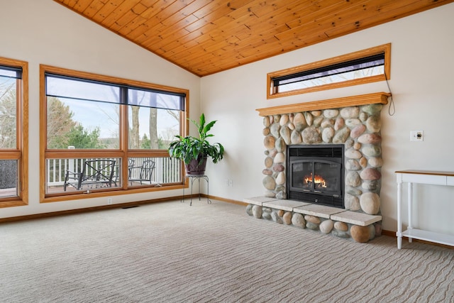 301 Hugh St, East Jordan, MI 49727 - unfurnished living room with vaulted ceiling, carpet, baseboards, a stone fireplace, and wood ceiling