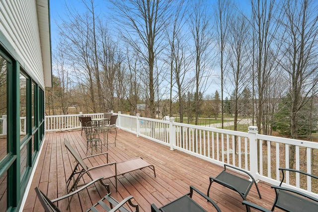301 Hugh St, East Jordan, MI 49727 - wooden terrace with outdoor dining area