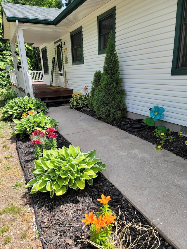 301 Hugh St, East Jordan, MI 49727 - view of exterior entry featuring covered porch