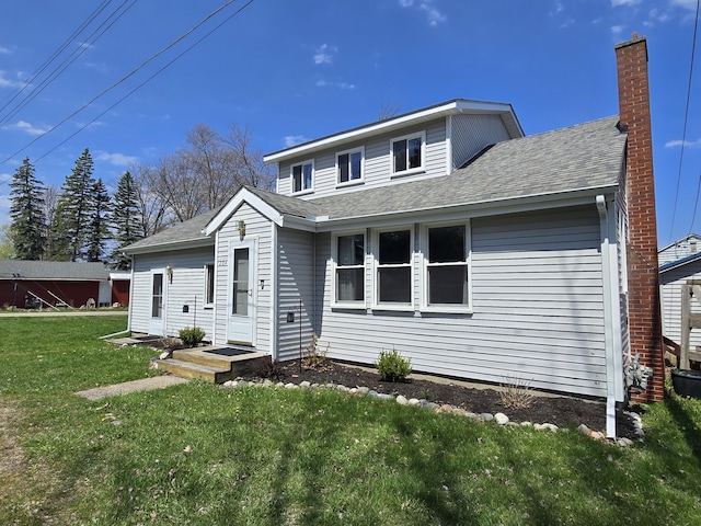 204 Broadway Rd, Houghton Lake, MI 48629 - view of front of property featuring a front yard, a shingled roof, and a chimney
