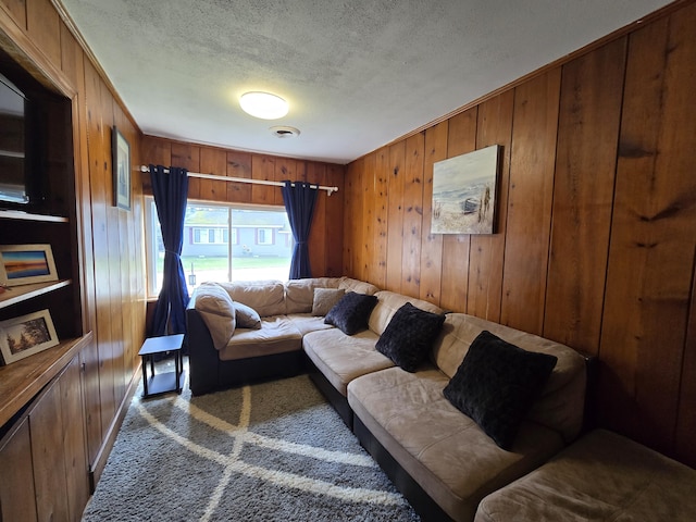 204 Broadway Rd, Houghton Lake, MI 48629 - living area featuring wood walls and a textured ceiling