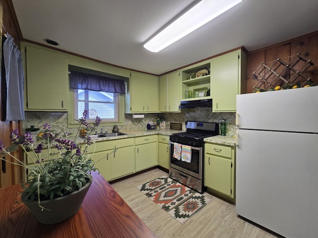 204 Broadway Rd, Houghton Lake, MI 48629 - kitchen with freestanding refrigerator, gas stove, under cabinet range hood, green cabinetry, and open shelves