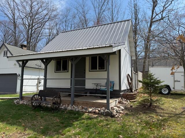 view of front of property with a garage and metal roof