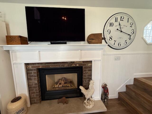 detailed view of a brick fireplace and wainscoting