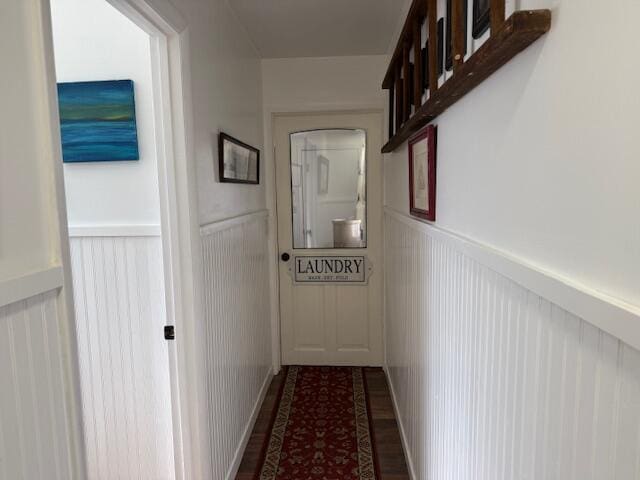 hall featuring wainscoting and wood finished floors