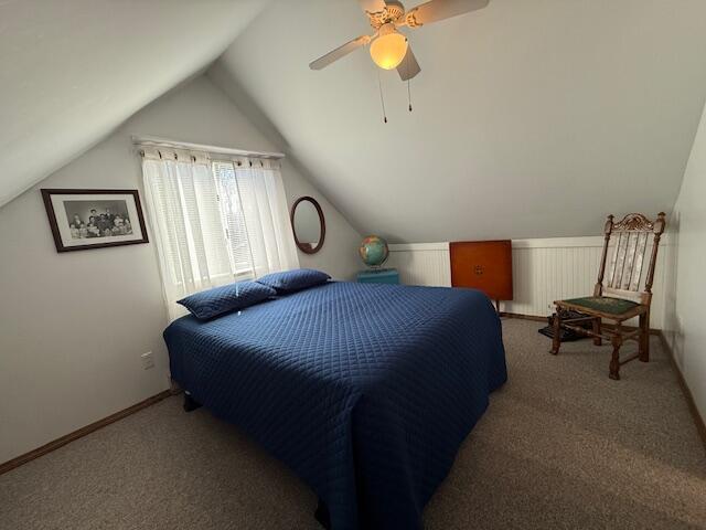 bedroom featuring vaulted ceiling, carpet, and a ceiling fan