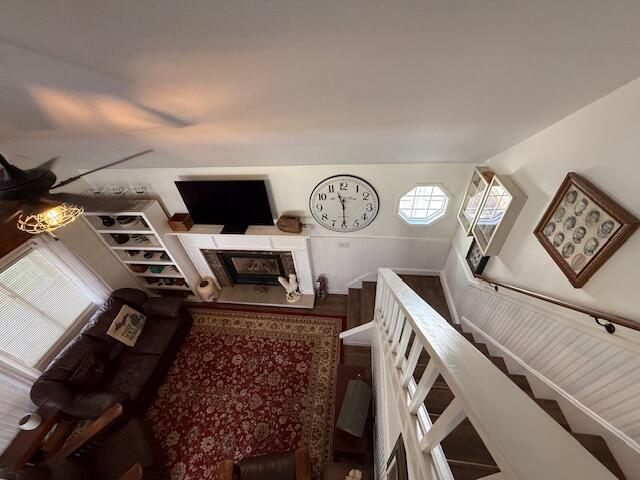 living area featuring wainscoting and a fireplace