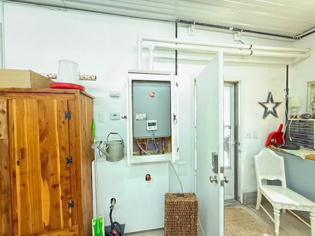 utility room featuring water heater