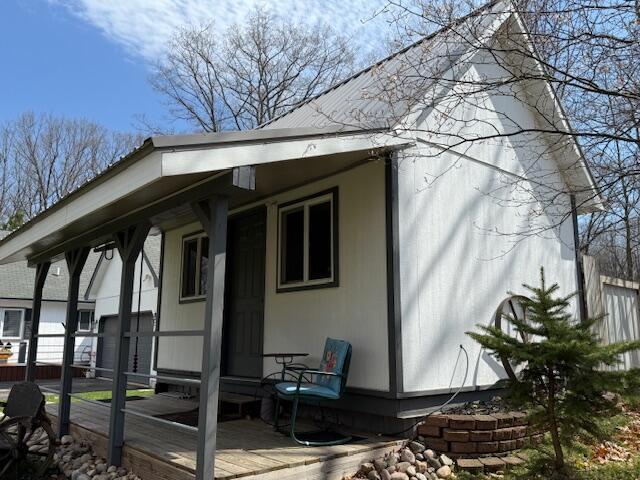 view of side of home with covered porch