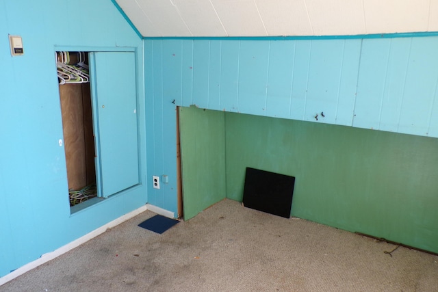 1220 Court St, Cheboygan, MI 49721 - unfurnished bedroom with carpet, vaulted ceiling, and a closet