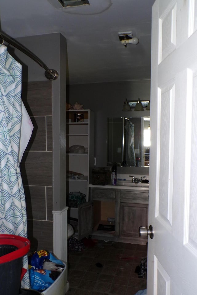 1220 Court St, Cheboygan, MI 49721 - full bathroom with vanity, curtained shower, and toilet