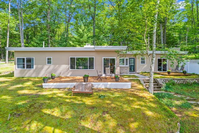2403 N Perch Lake Dr, Gaylord, MI 49735 - back of house featuring a wooden deck and a yard