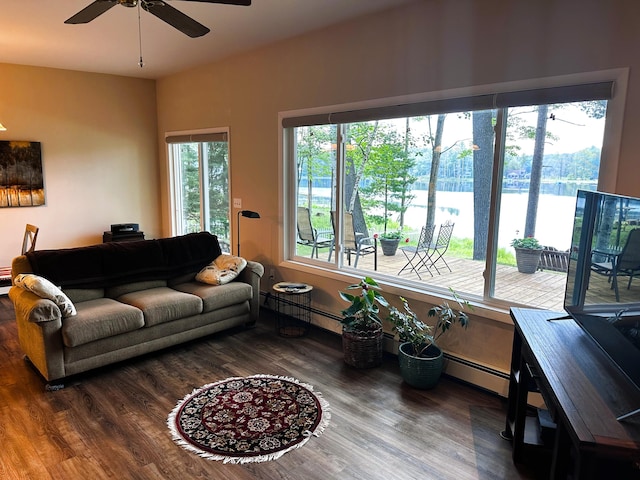 2403 N Perch Lake Dr, Gaylord, MI 49735 - living area featuring a baseboard heating unit, a ceiling fan, plenty of natural light, and wood finished floors