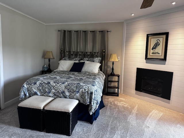 2403 N Perch Lake Dr, Gaylord, MI 49735 - carpeted bedroom with crown molding, a large fireplace, recessed lighting, baseboards, and wooden walls