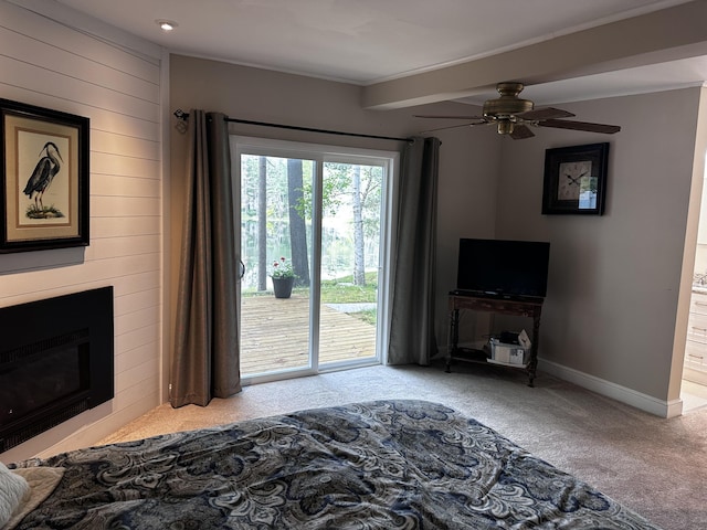 2403 N Perch Lake Dr, Gaylord, MI 49735 - carpeted bedroom featuring access to outside, wood walls, a fireplace, baseboards, and ornamental molding