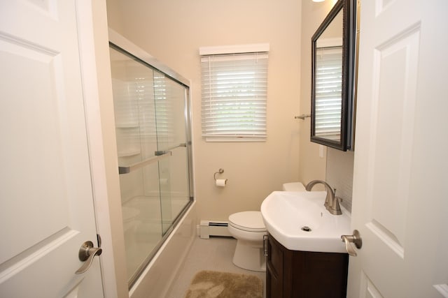 2403 N Perch Lake Dr, Gaylord, MI 49735 - full bath featuring a baseboard radiator, vanity, toilet, shower / bath combination with glass door, and baseboards