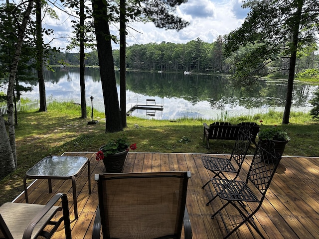2403 N Perch Lake Dr, Gaylord, MI 49735 - wooden deck featuring a water view, a forest view, and a dock