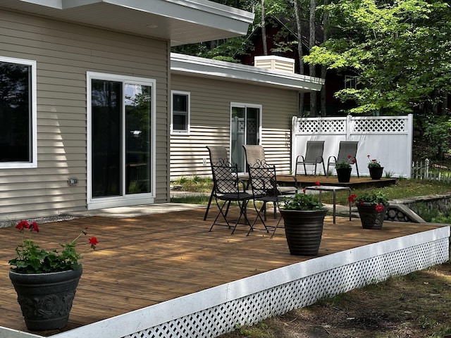 2403 N Perch Lake Dr, Gaylord, MI 49735 - wooden terrace with outdoor dining space and fence