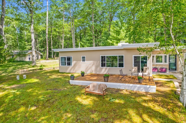 2403 N Perch Lake Dr, Gaylord, MI 49735 - rear view of property with a deck and a yard