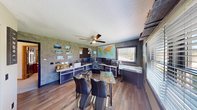 3400 Thornapple Trl, Lewiston, MI 49756 - dining area with wood finished floors, ceiling fan, a desk, a textured ceiling, and baseboards