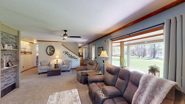 3400 Thornapple Trl, Lewiston, MI 49756 - living area featuring a stone fireplace, carpet floors, crown molding, a textured ceiling, and a ceiling fan
