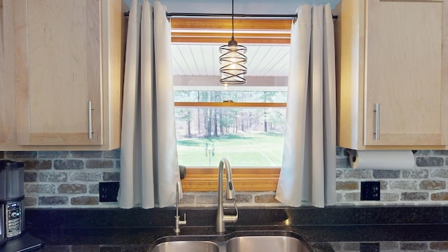 3400 Thornapple Trl, Lewiston, MI 49756 - kitchen featuring a sink, tasteful backsplash, light brown cabinets, and dark stone counters