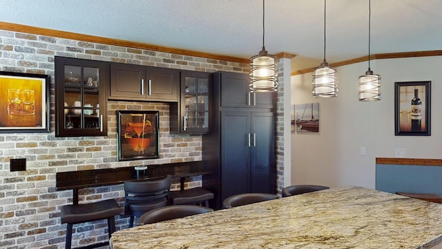 3400 Thornapple Trl, Lewiston, MI 49756 - kitchen with pendant lighting, light stone counters, a kitchen breakfast bar, glass insert cabinets, and crown molding