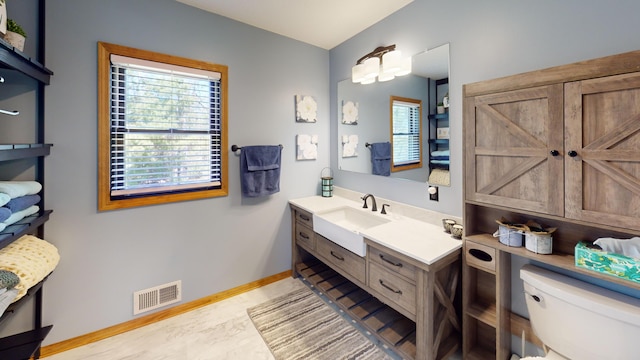 3400 Thornapple Trl, Lewiston, MI 49756 - bathroom featuring toilet, baseboards, and vanity