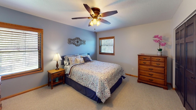 3400 Thornapple Trl, Lewiston, MI 49756 - bedroom with light carpet, baseboards, and ceiling fan