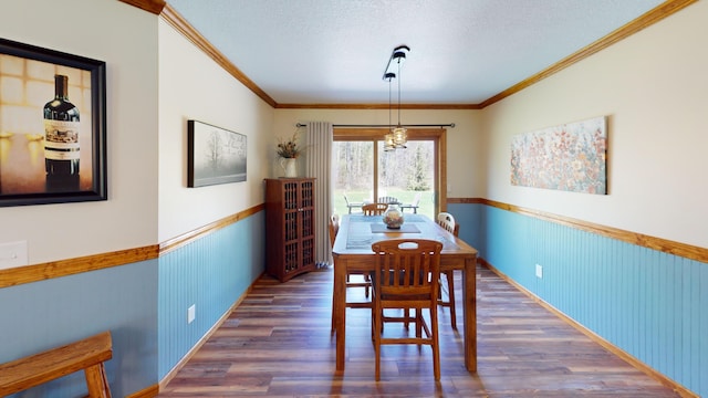 3400 Thornapple Trl, Lewiston, MI 49756 - dining room with wood finished floors, wainscoting, crown molding, and a textured ceiling