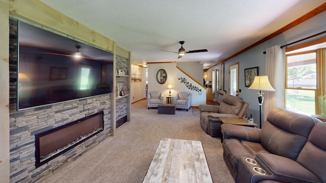 3400 Thornapple Trl, Lewiston, MI 49756 - carpeted living area featuring ceiling fan, a textured ceiling, a stone fireplace, and ornamental molding