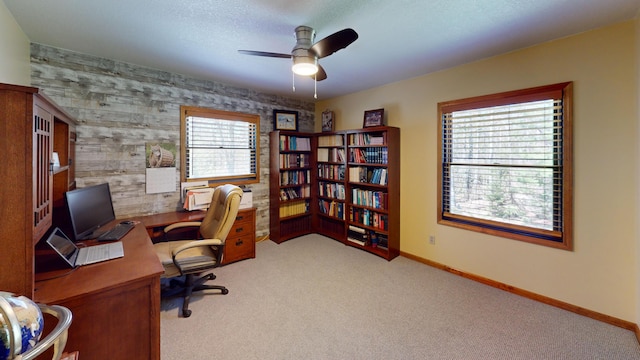 3400 Thornapple Trl, Lewiston, MI 49756 - carpeted office space featuring a ceiling fan, baseboards, and an accent wall