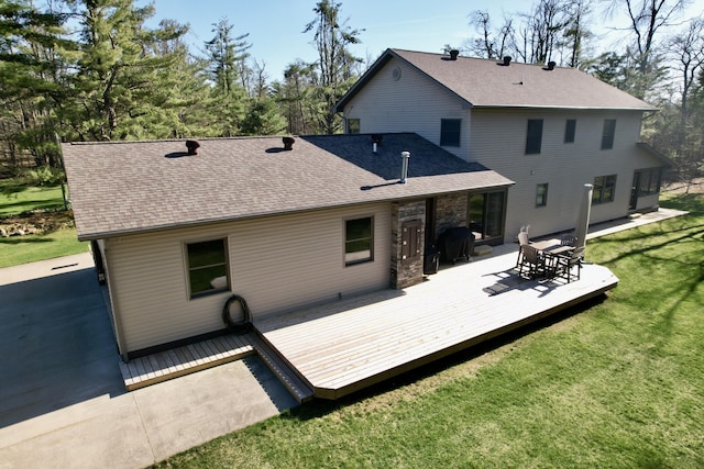 3400 Thornapple Trl, Lewiston, MI 49756 - rear view of property with a shingled roof, a yard, and a deck