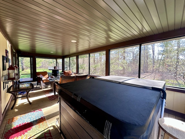 3400 Thornapple Trl, Lewiston, MI 49756 - sunroom featuring plenty of natural light, wood-type flooring, and a hot tub