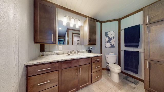 3400 Thornapple Trl, Lewiston, MI 49756 - bathroom with toilet, vanity, tile patterned floors, and baseboards