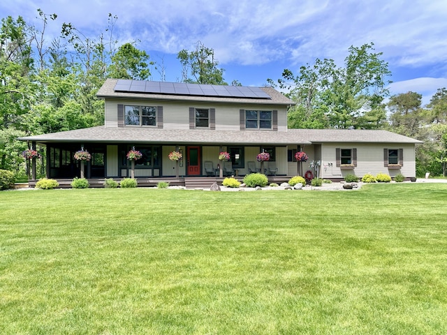 3400 Thornapple Trl, Lewiston, MI 49756 - country-style home with roof mounted solar panels, a front lawn, covered porch, and roof with shingles