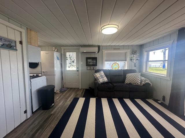 living room with a wall mounted air conditioner and dark wood-style flooring