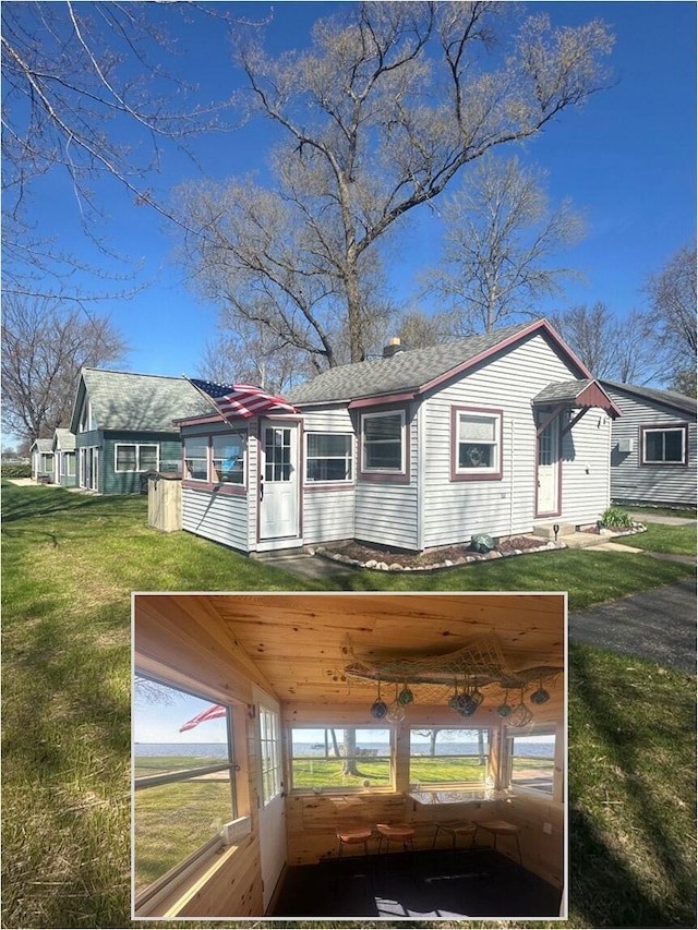 8139 E Houghton Lake Dr, Houghton Lake, MI 48629 - view of front of home with a front yard and roof with shingles