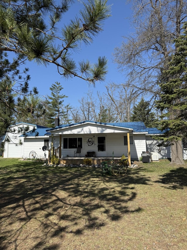 4210 County Road 491, Lewiston, MI 49756 - rear view of property with covered porch and a yard