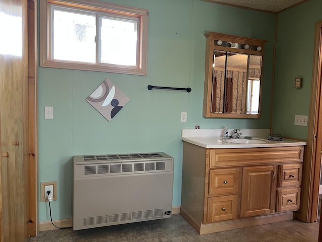 4210 County Road 491, Lewiston, MI 49756 - bathroom with heating unit, vanity, baseboards, and radiator heating unit