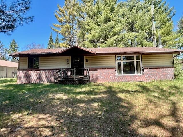 2165 E Cherry Creek Rd, Fairview, MI 48621 - back of property with brick siding and a yard