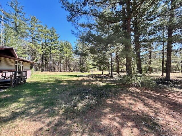 2165 E Cherry Creek Rd, Fairview, MI 48621 - view of grassy yard with a deck