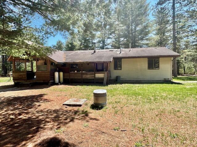 2165 E Cherry Creek Rd, Fairview, MI 48621 - rear view of property featuring a lawn