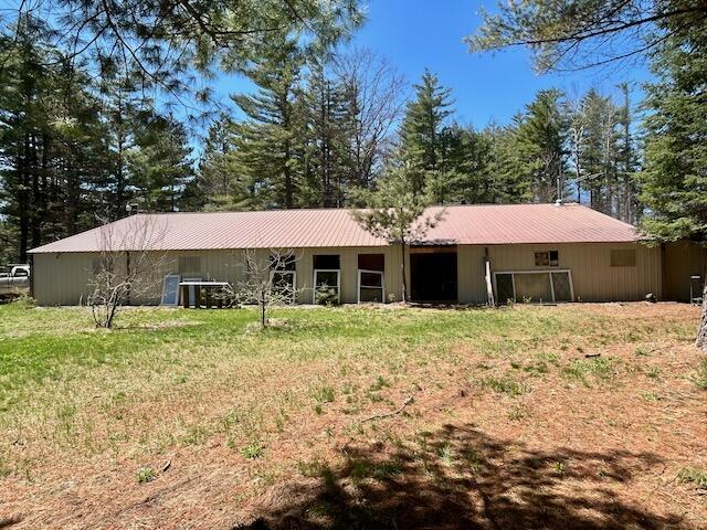 2165 E Cherry Creek Rd, Fairview, MI 48621 - rear view of house with metal roof