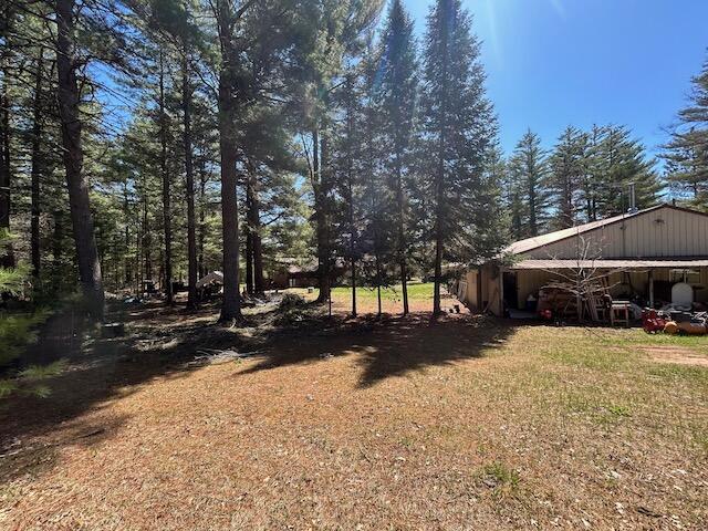 2165 E Cherry Creek Rd, Fairview, MI 48621 - view of yard featuring a pole building and an outdoor structure