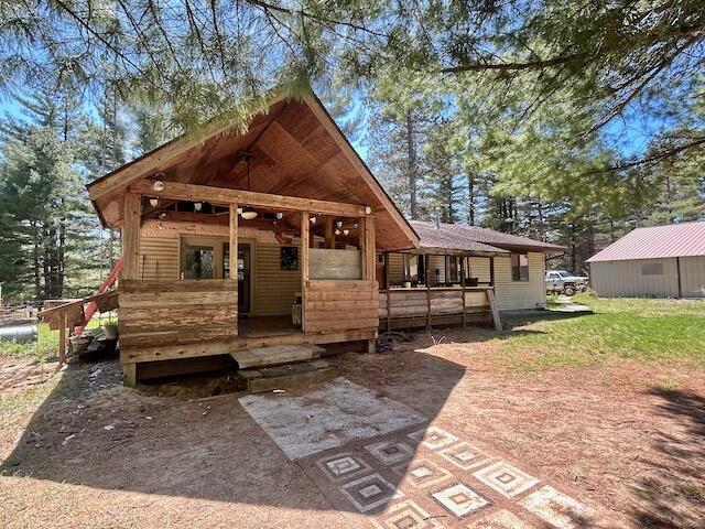 2165 E Cherry Creek Rd, Fairview, MI 48621 - rear view of house featuring a deck